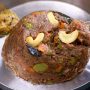 finger millets upma garnished with cashewnuts and chutney served in a round steel plate